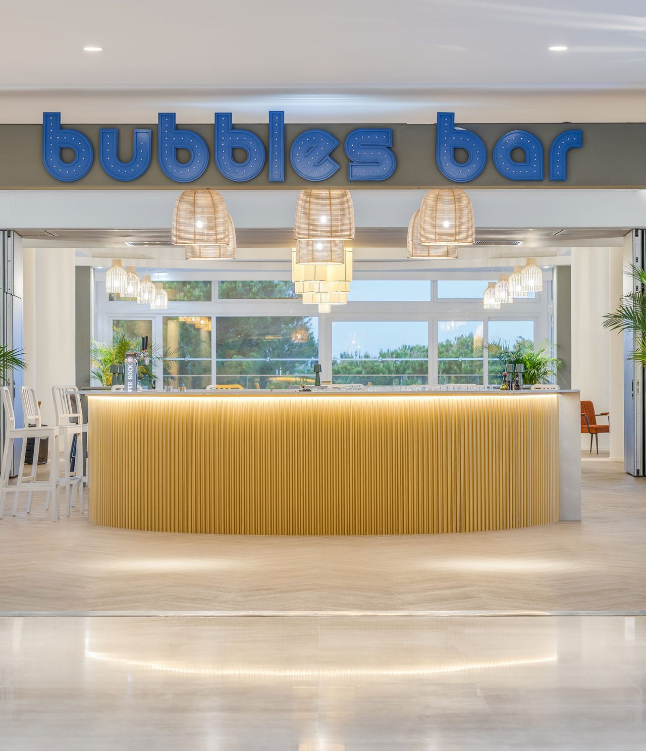 Bubbles Bar’s circular, light wood counter features a tasteful logo for a stylish atmosphere