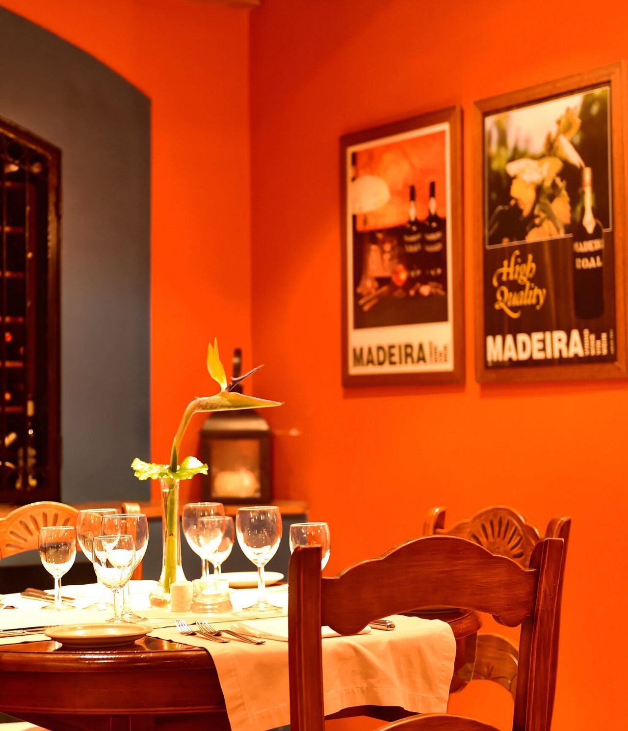 The Adega Madeirense restaurant, at the Romantic Hotel in Funchal, Madeira, has a round table and two paintings