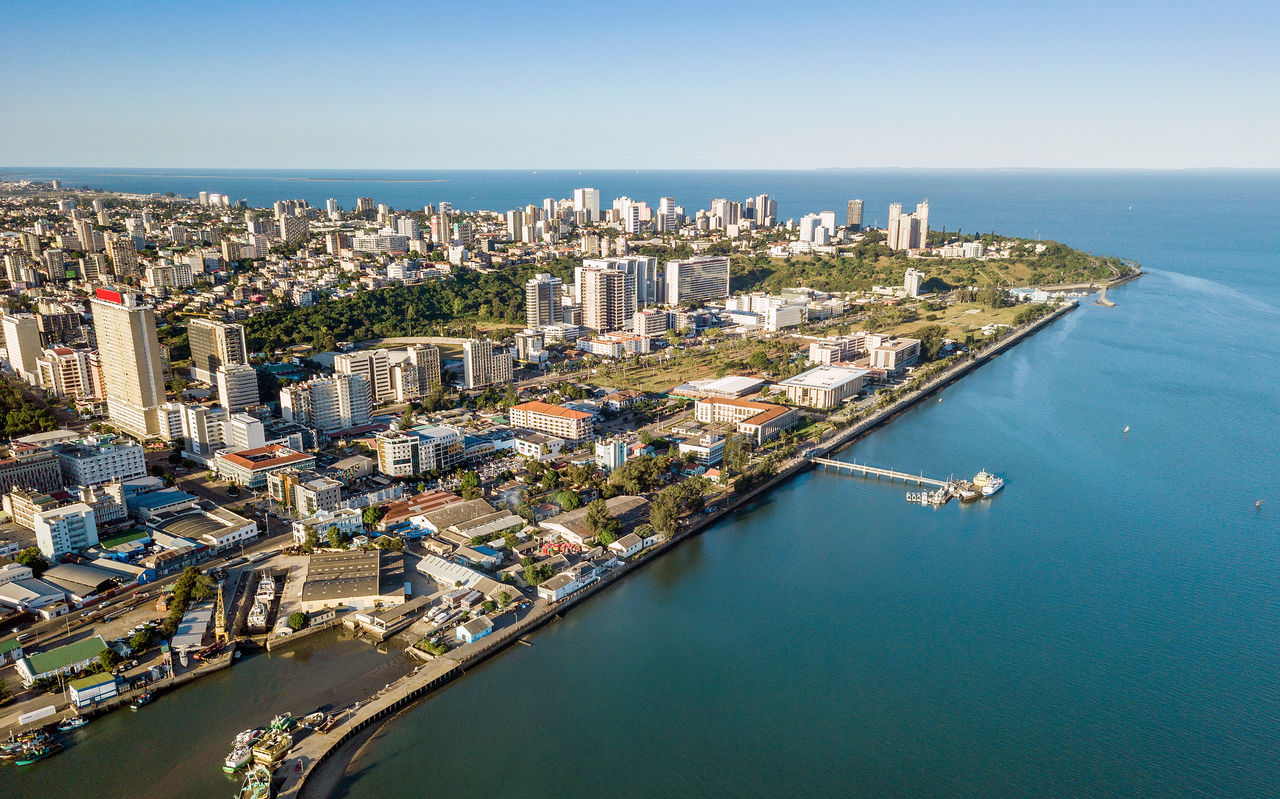 Aerial view of Maputo, the capital of Mozambique, with various concentrations of buildings and the sea around