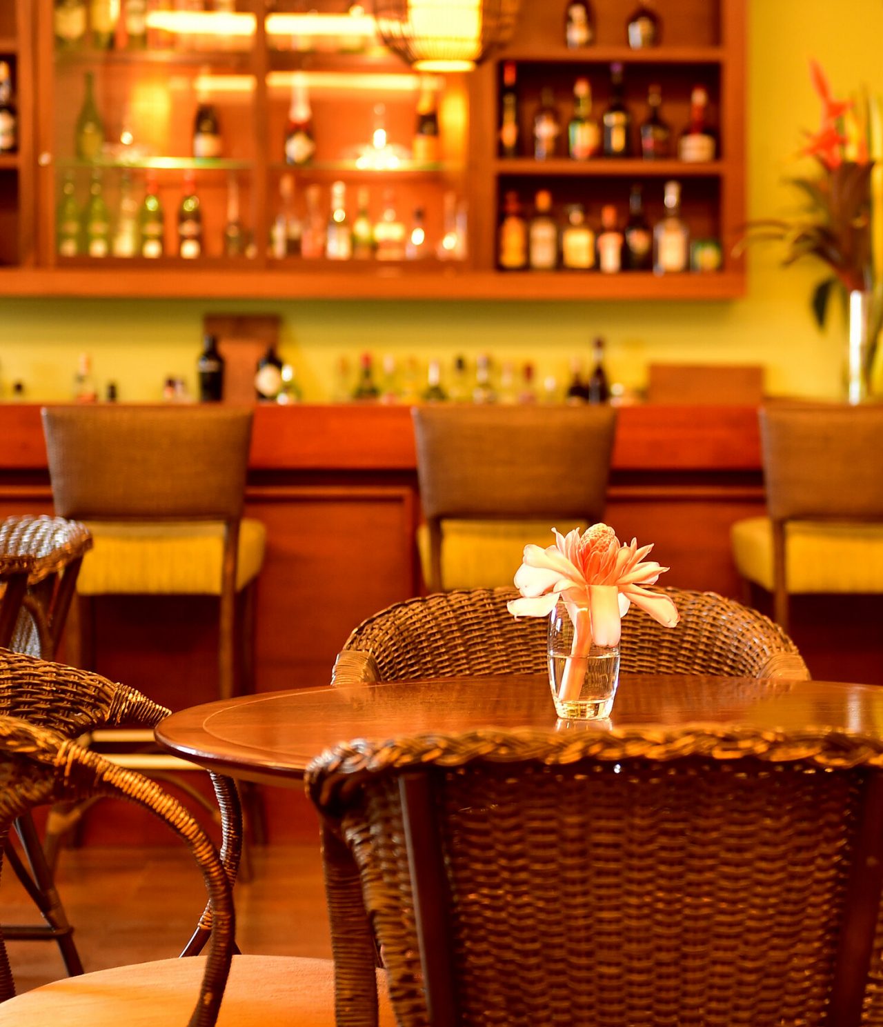 The Uê D'Omale Bar, at the 5-Star Resort in São Tomé, has tables with flowers and serves a variety of drinks and cocktails