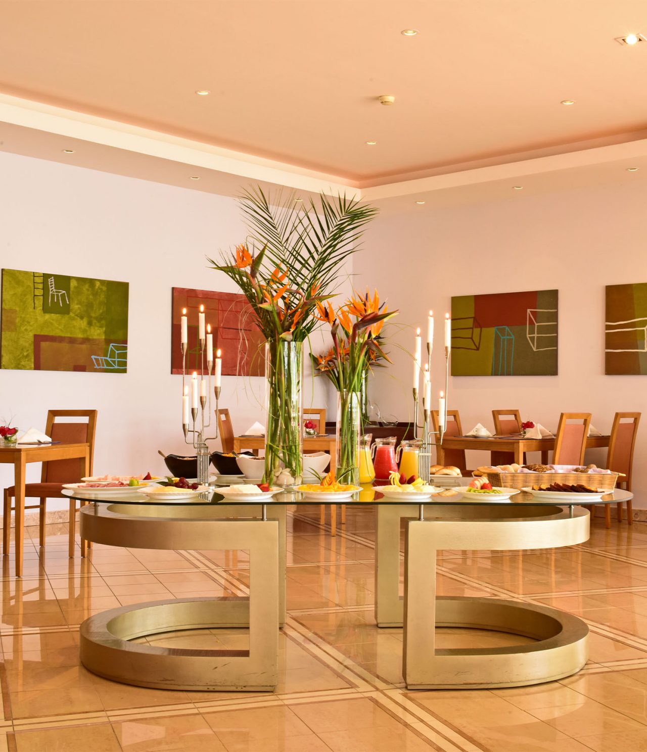 A Adega has a central table with breakfast options like fruit and bread