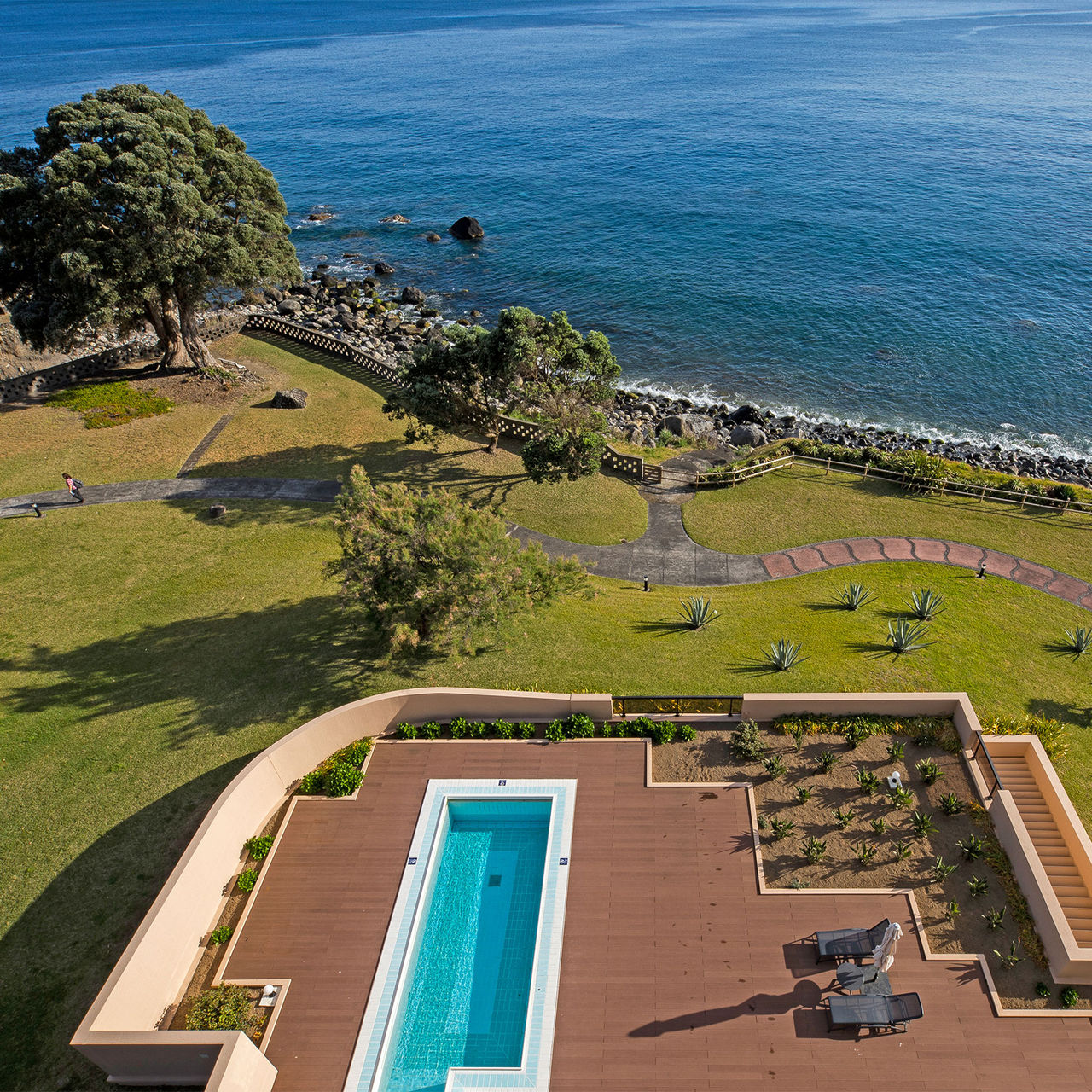 Top view of the pool at Pestana Bahia Praia, surrounded by gardens with the sea around