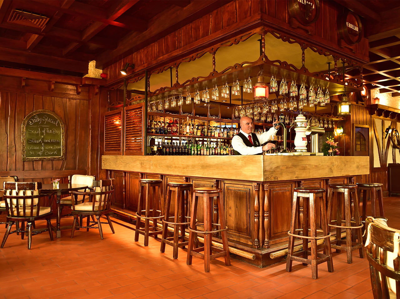 The Pub has a counter surrounded by tall stools and a variety of drinks