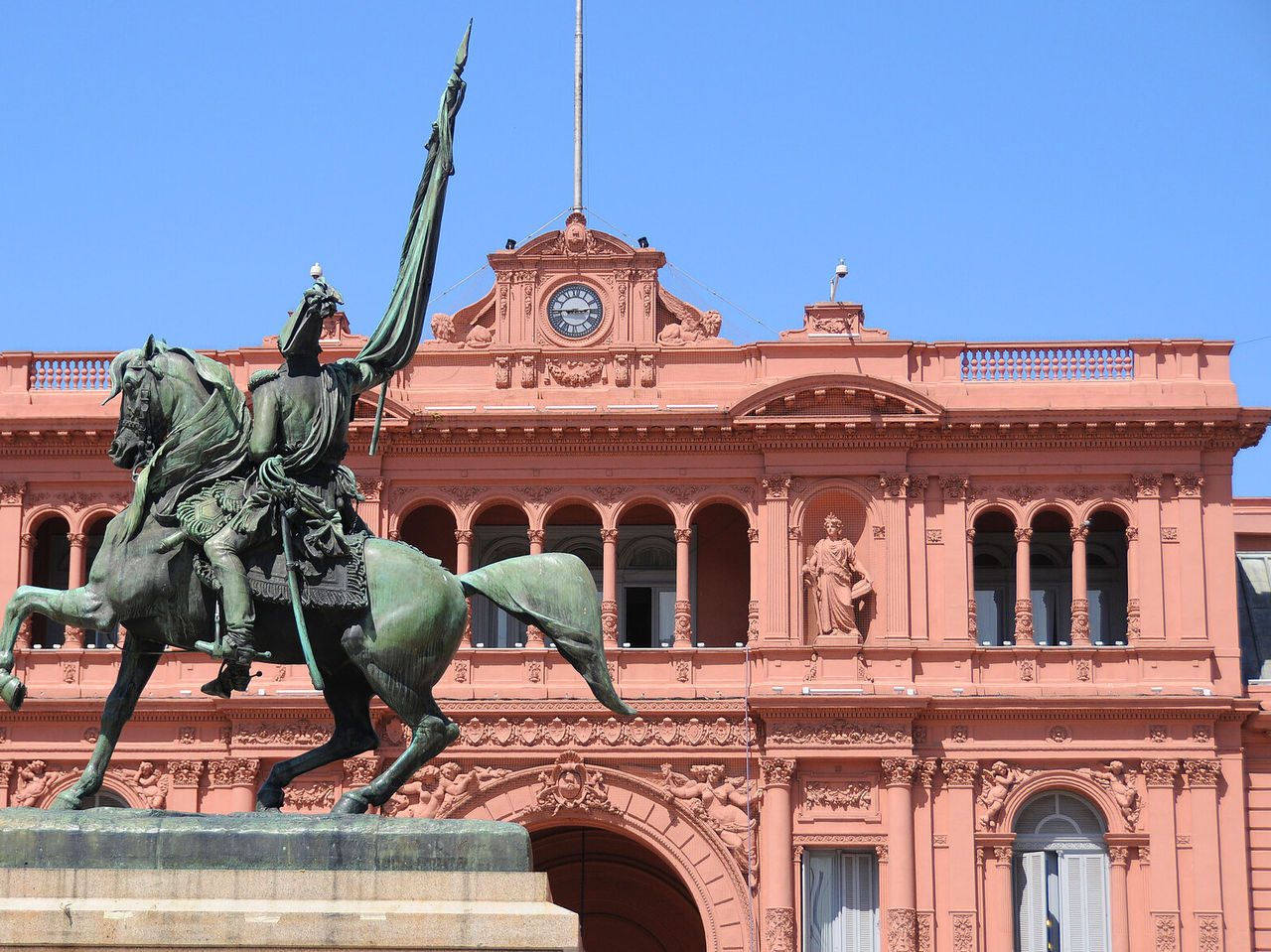Explore Hotels in Buenos Aires featuring the pink presidential palace and equestrian statue beneath blue skies