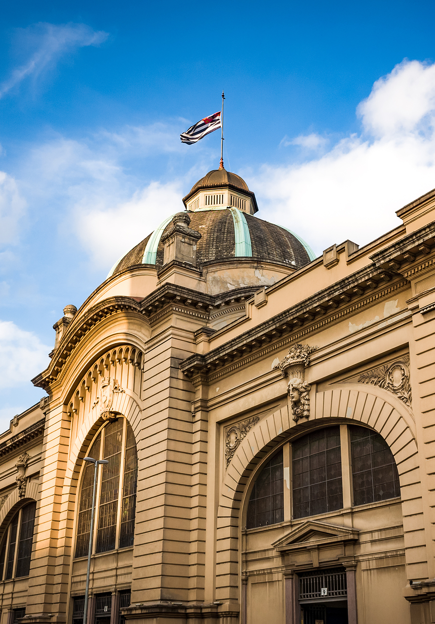 Municipal Market of São Paulo or Mercadão has a grand facade adorned with elegant arches and colorful stained glass