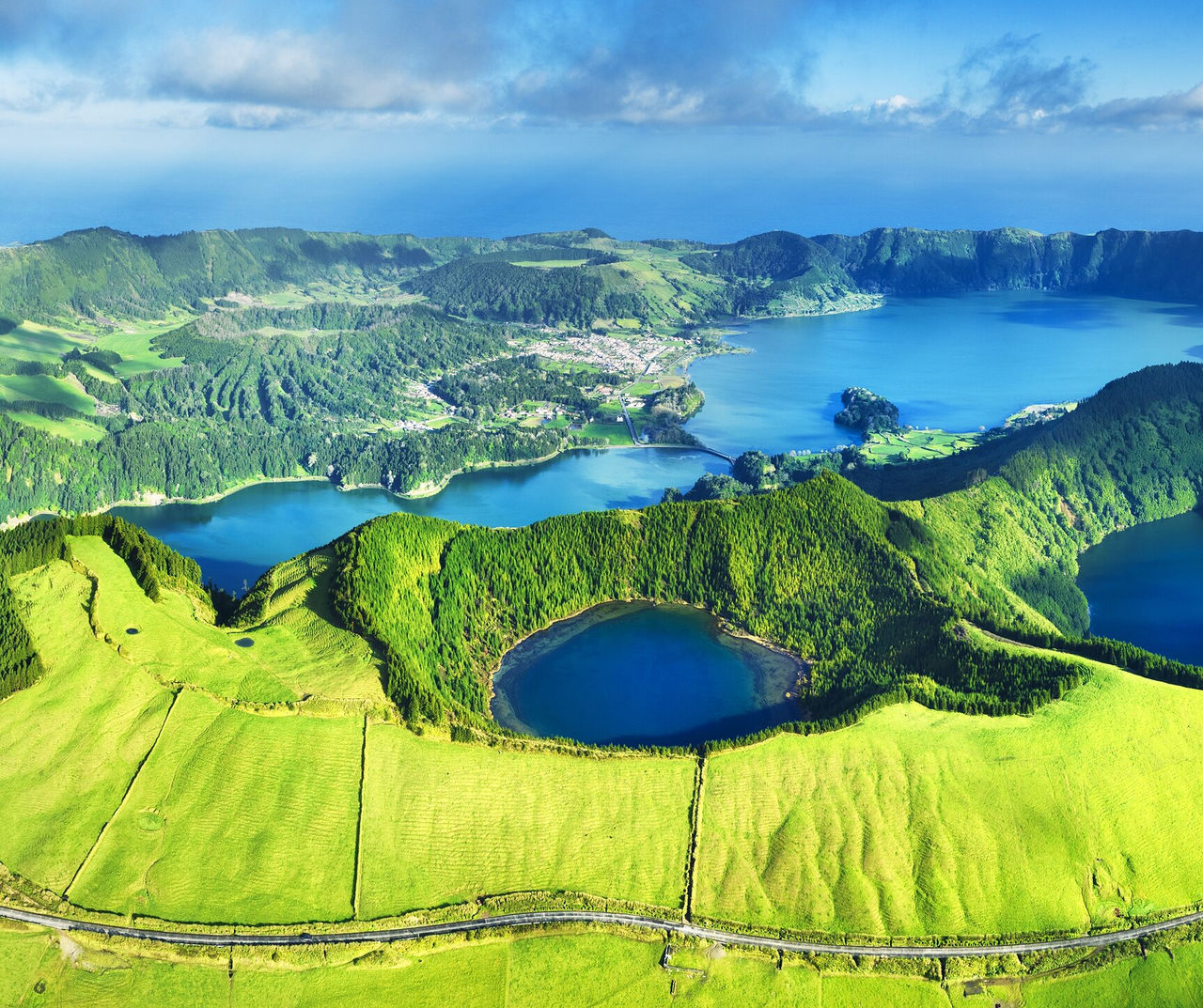 azores hotel featuring an aerial view of green volcanic lakes, rolling hills and Atlantic coastline