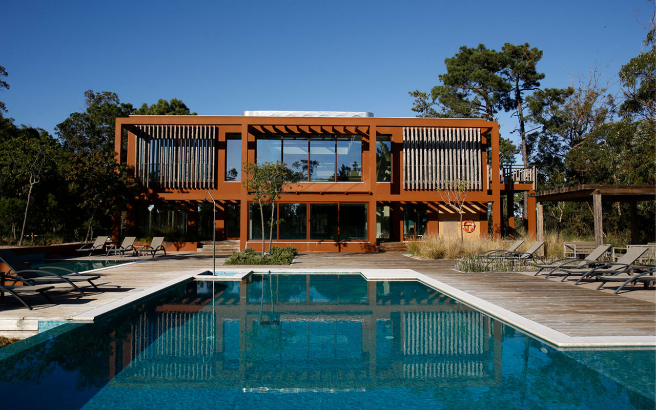 Villas with outdoor pool and sun loungers, at Eco Resort in Portugal, belonging to the Pestana Residences brand