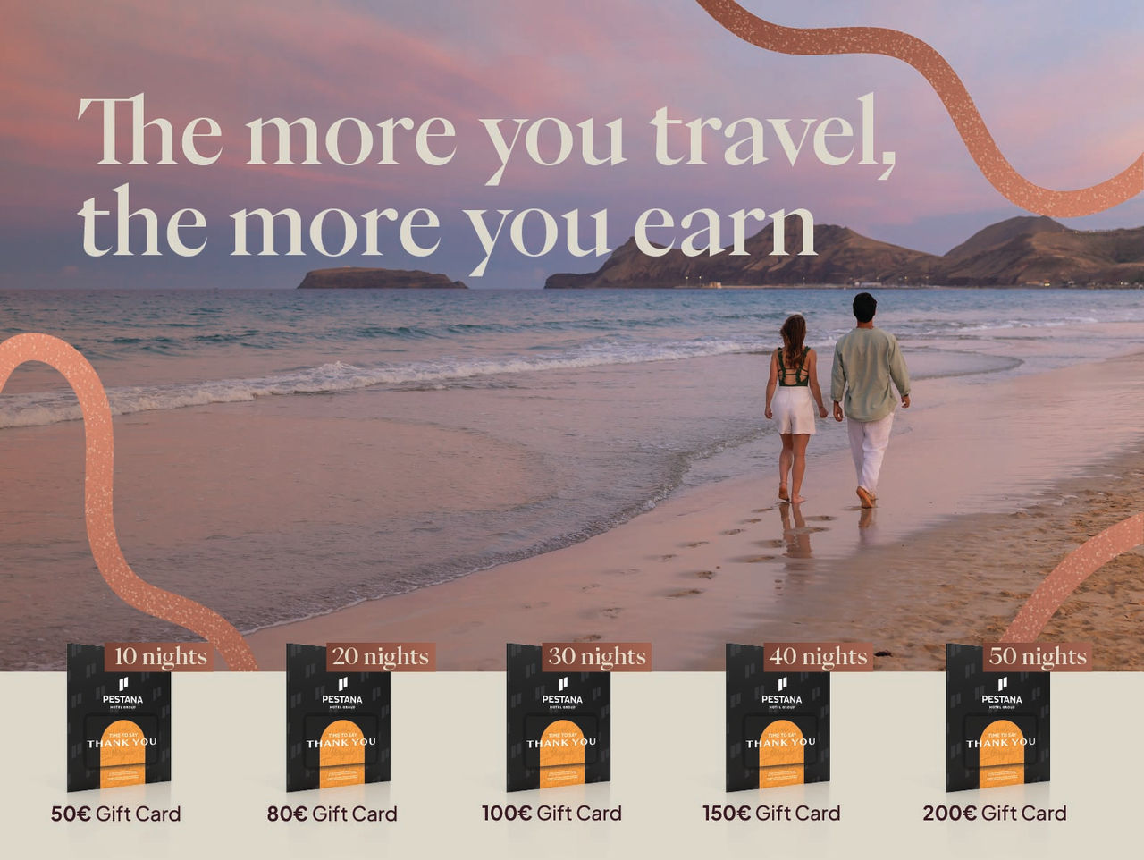 Couple walking along a beach at sunset beside island cliffs with travel rewards and gift card offers displayed